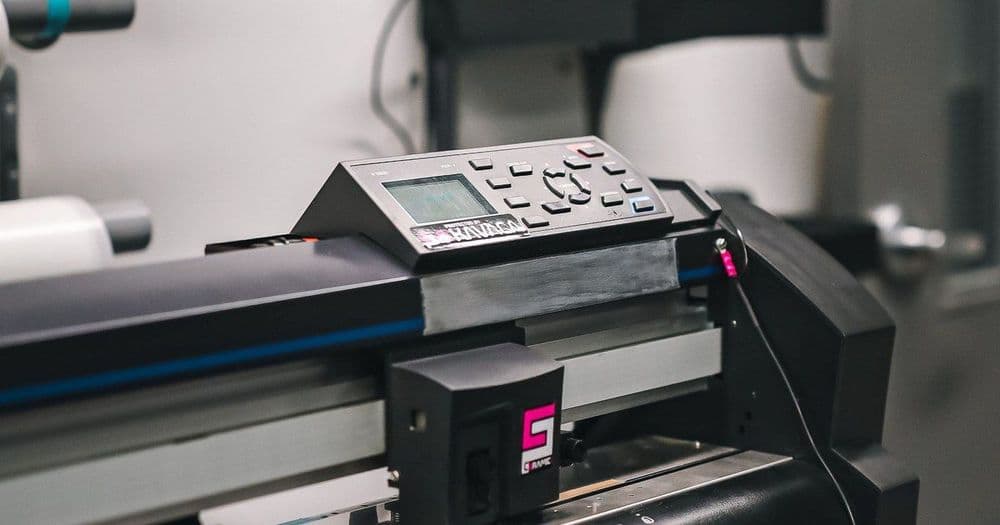 Wide-format cutting plotter at work in a small print shop